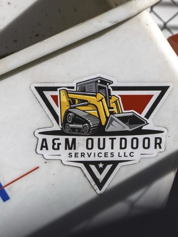 A&M Outdoor Services logo decal on a work trailer